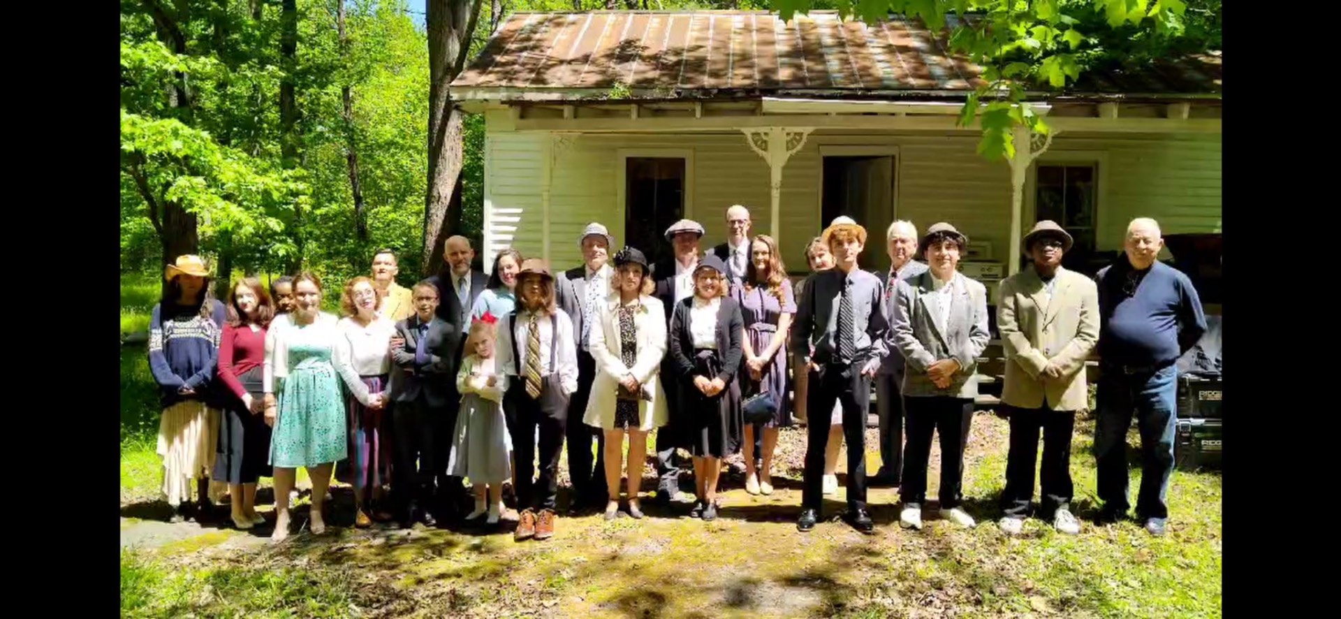 The Grover's Mill cast on location — group photograph in period costume outside a period house